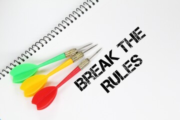 arrows, white paper with the words break the rules