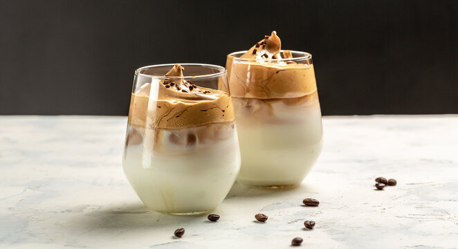 Dalgona coffee, Korean coffee drink instant coffee or espresso powder whipped with sugar and hot water In a transparent glass. Trendy drink latte