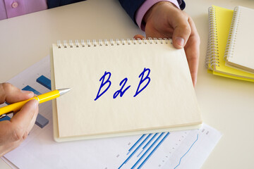 Business concept about B2B business-to-business with sign on the writing-pad.