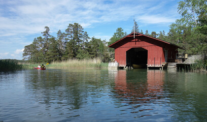 Fototapeta na wymiar Red wooden boathouse