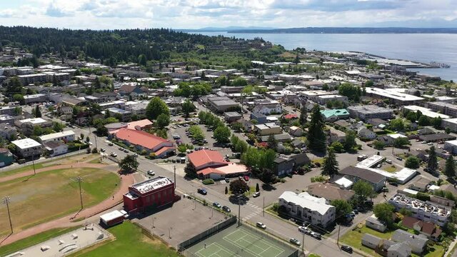 Cinematic 4K drone trucking shot of the downtown Edmonds commercial area, Kingston ferry terminal waterfront marina, near Seattle in Western Washington, Pacific Northwest, in Snohomish County