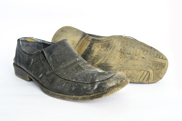 Old dirty shoes isolated in white background