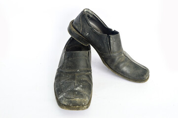 Old dirty shoes isolated in white background