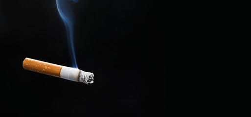 Smoking cigarette on dark background
