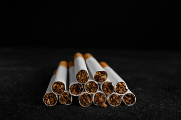 Many cigarettes on dark background