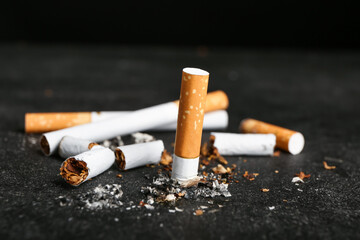 Many cigarettes on dark background