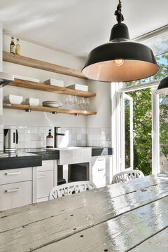 Well Organized Small Home Kitchen Interior With Sink And Light Furniture