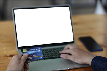 Close up hands holding credit card and using laptop. Online shopping