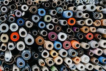 Closeup of rolls of colorful textile and fabric for roller blinds in a factory