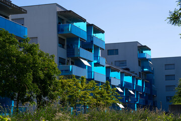 Apartment building at Zurich Schlieren with stylish blue balconies at a sunny summer morning. Photo...