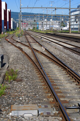 Close-up of railway switch st train station Zurich Schlieren at a beautiful summer day. Photo taken...