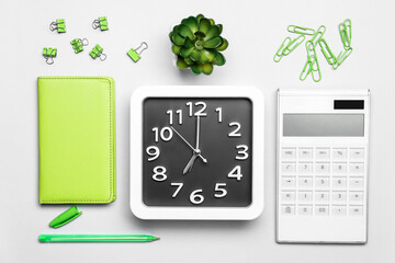 Composition with stylish clock and stationery on light background