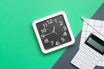 Composition with stylish clock and calculator on color background