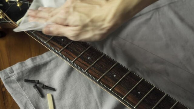 Cleaning guitar fretboard with wet wipes made for guitar