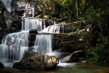 Mountain river background with small waterfalls in tropical forest.