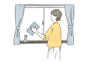 窓を掃除する女性