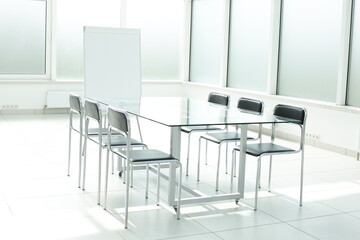 Flipchart glass table and chairs in office space