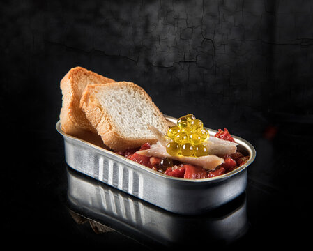 Roasted red bell peppers with fresh bread and yellow roe with fish meat in tin can