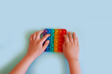 Children's hands hold Silicone colorful toy Pop It