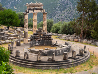 Panoramic view on Temple Athena Pronaia among the mountains in Delphi, Greece against a stormy sky
