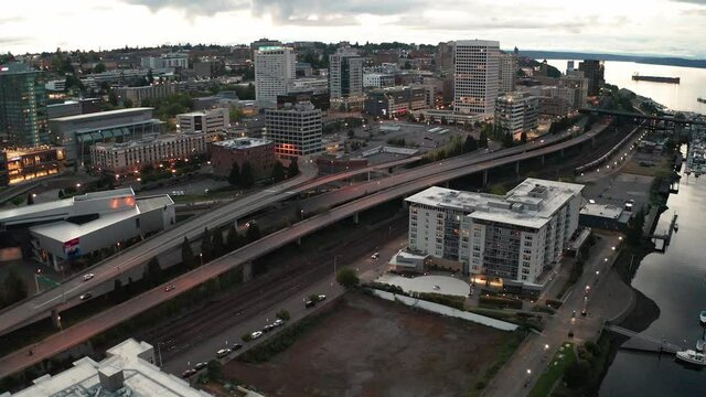 Cinematic 4K night aerial drone footage of the downtown commercial and waterfront area of Tacoma, a city near Seattle in Western Washington, Pacific Northwest, the economic center of Pierce County