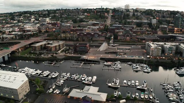 Cinematic 4K evening aerial drone footage of the downtown commercial and waterfront area of Tacoma, a city near Seattle in Western Washington, Pacific Northwest, the economic center of Pierce County
