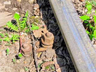 Old railway rail and rusty fasteners