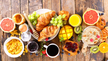 breakfast with coffee cup, croissant and fresh fruits