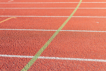 Fototapeta premium Red running track Synthetic rubber on the athletic stadium outdoor.Part shot.