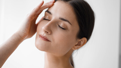 Fototapeta premium Beautiful woman face close up brunette natural make up happy smile natural beauty over white