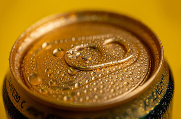 condensate on a cold metal beer can on a yellow background