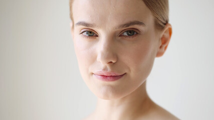 Beautiful woman face close up blonde short hair natural make up