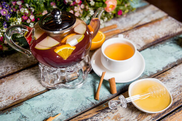 tea ceremony with fruit tea with honey on a wooden background