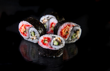 japanese roll s with an interesting design on a black background.