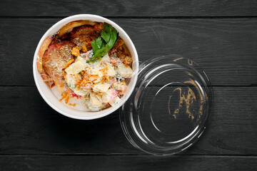 Fried ham with salad sprinkled with bacon chips and grated parmesan