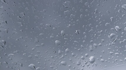 view close up of raindrops on the glass window in the morning