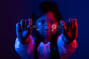 Asian child girl holding high-tech eyeglasses in her hand