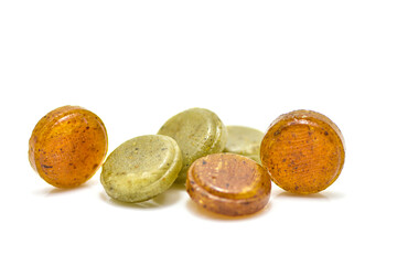 Medical lozenges for relief cough, sore throat and throat irritation isolated on white background. Cough and colds drop. round candy .