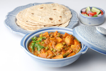 Mix vegetable curry with Naan or Indian bread and raita, Indian meal