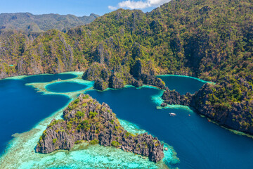 Aerial view of turquoise tropical lagoon with limestone cliffs in Coron Island, Palawan, Philippines. UNESCO World Heritage.