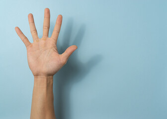 Hand a man on blue background with a copy space.
