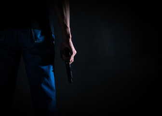 A man holding a pistol gun with a copy space. Criminal concept.