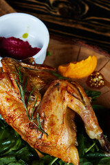 chicken broiler with herbs on a round wooden board