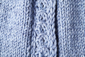 Fototapeta premium blue knitted product on knitting needles on a white background