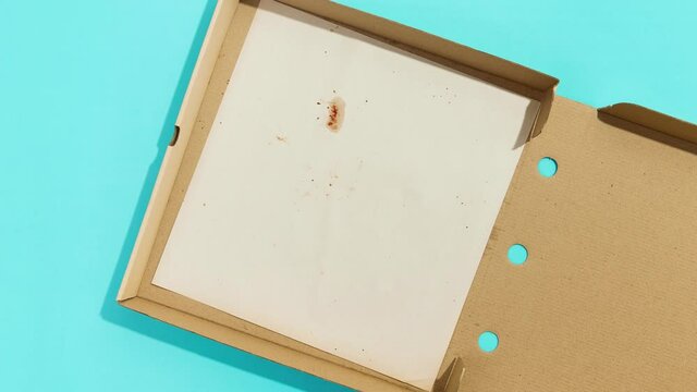 Pizza in the box on blue table. Flat lay top view food delivery concept