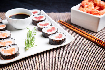 Plate with sushi, shrimp bowl and wooden chopsticks. Asian food. Healthy food concept