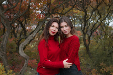 Fototapeta premium Mature mother hugging with her teen daughter outdoor in nature
