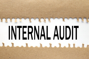 Internal Audit. text on torn cardboard. black letters on white paper