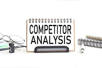 competitor analysis. Business and management concept. text on notepad. on a white background near...
