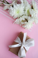 postcard mockup. small bouquet of white chrysanthemums, envelope, white blank for text and pearl beads 
